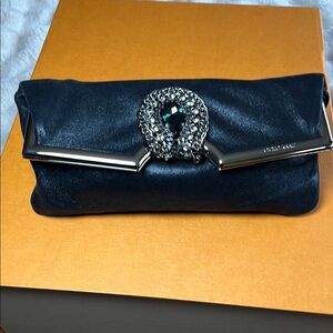 Jimmy Choo Black Clutch with rhinestone detail.